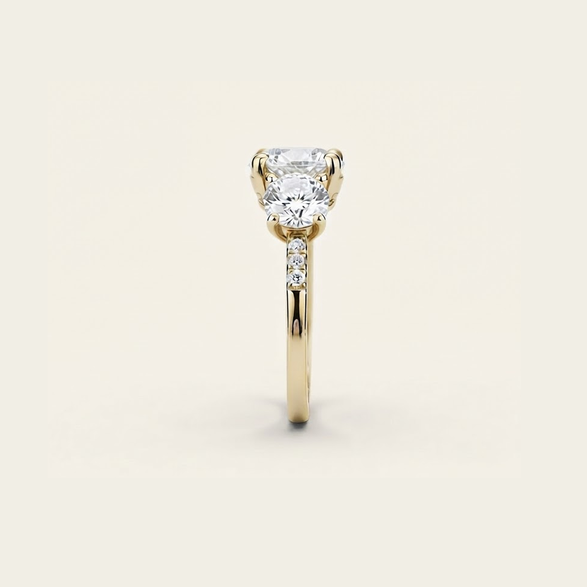 Side profile of the Celia Ring in gold, showing the raised prong setting and pavé accents along the band.

variant: yellow-gold