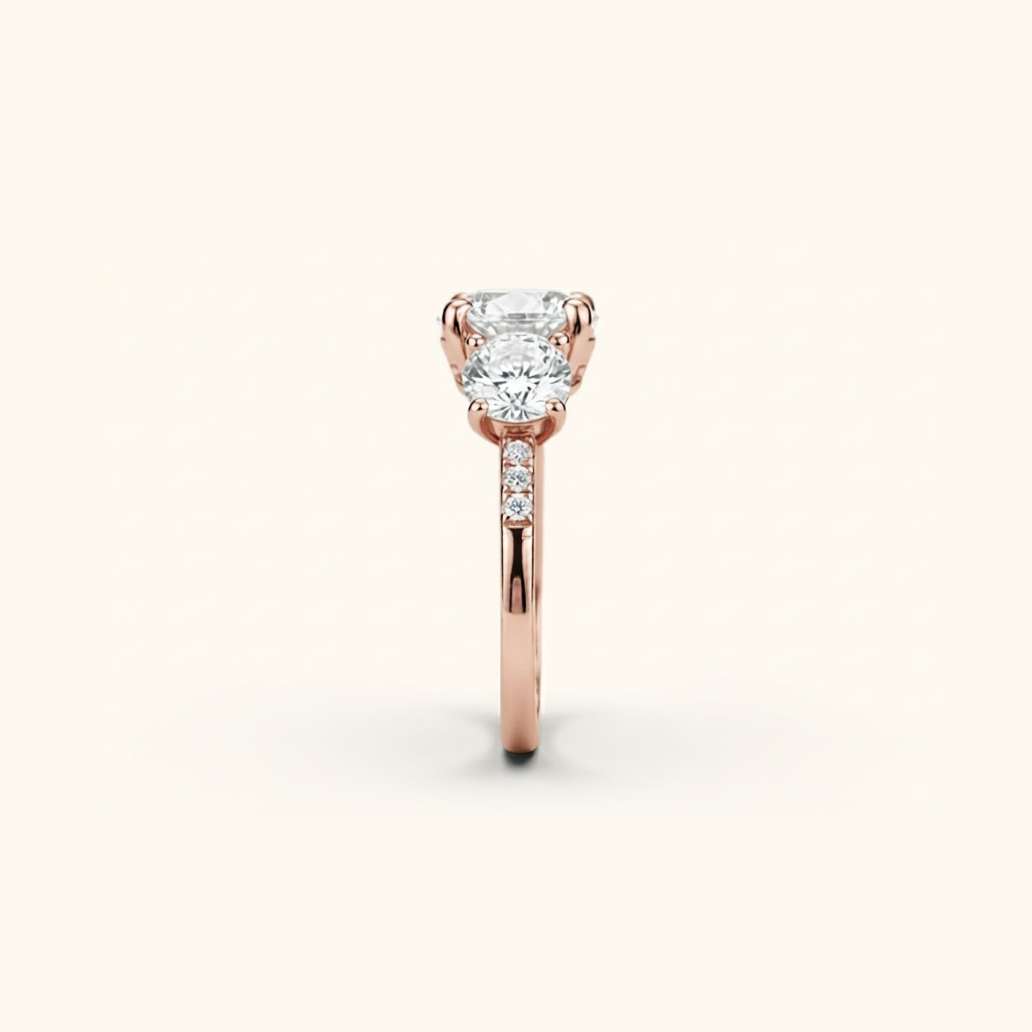 Side profile of the Celia Ring in rose gold, showing the raised prong setting and pavé accents along the band.

variant: rose-gold