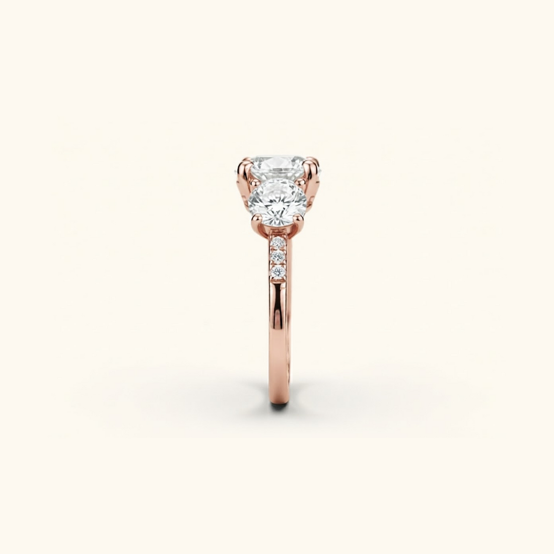 Side profile of the Celia Ring in rose gold, showing the raised prong setting and pavé accents along the band.

variant: rose-gold