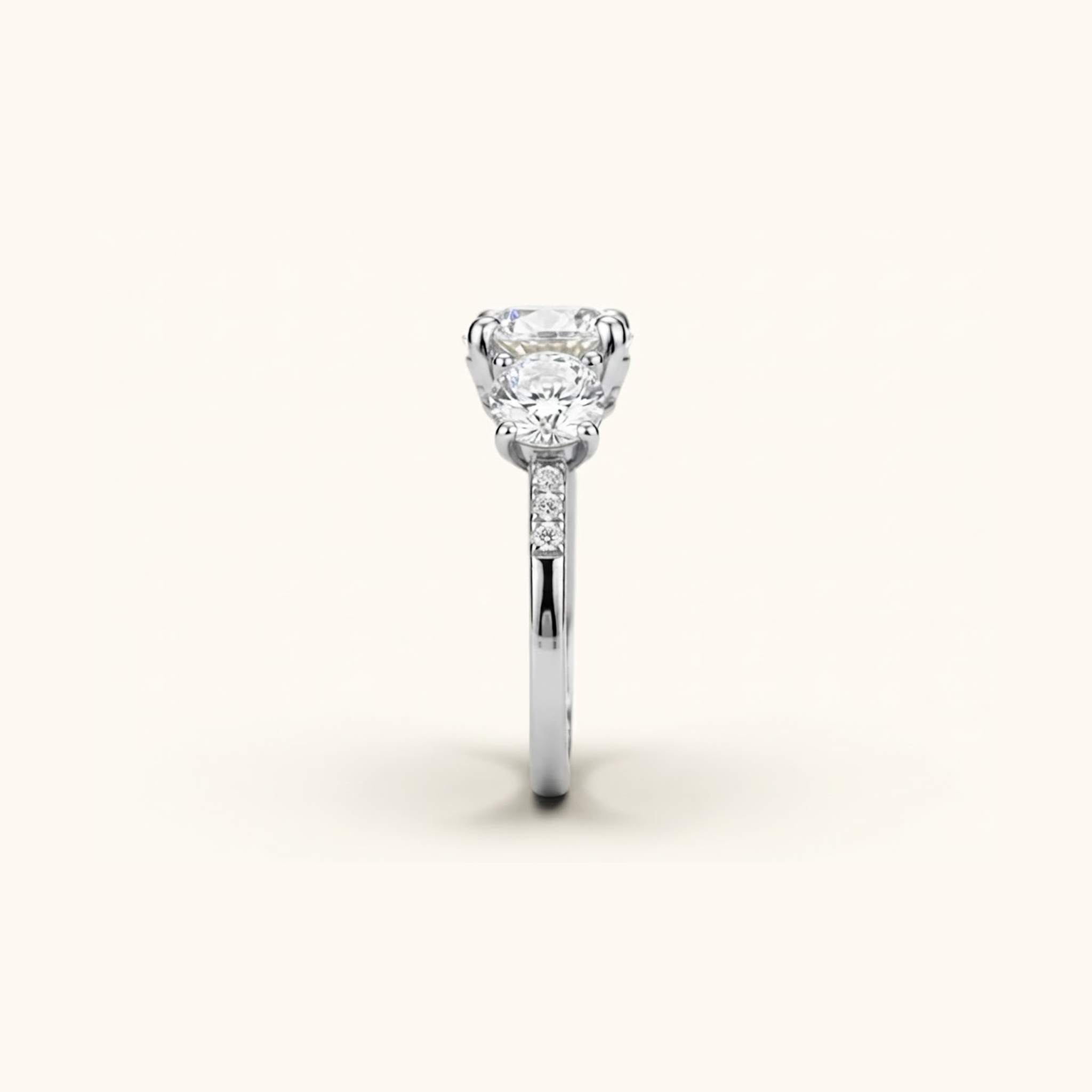 Side profile of the Celia Ring in silver or platinum, showing the raised prong setting and pavé accents along the band.

variant: silver