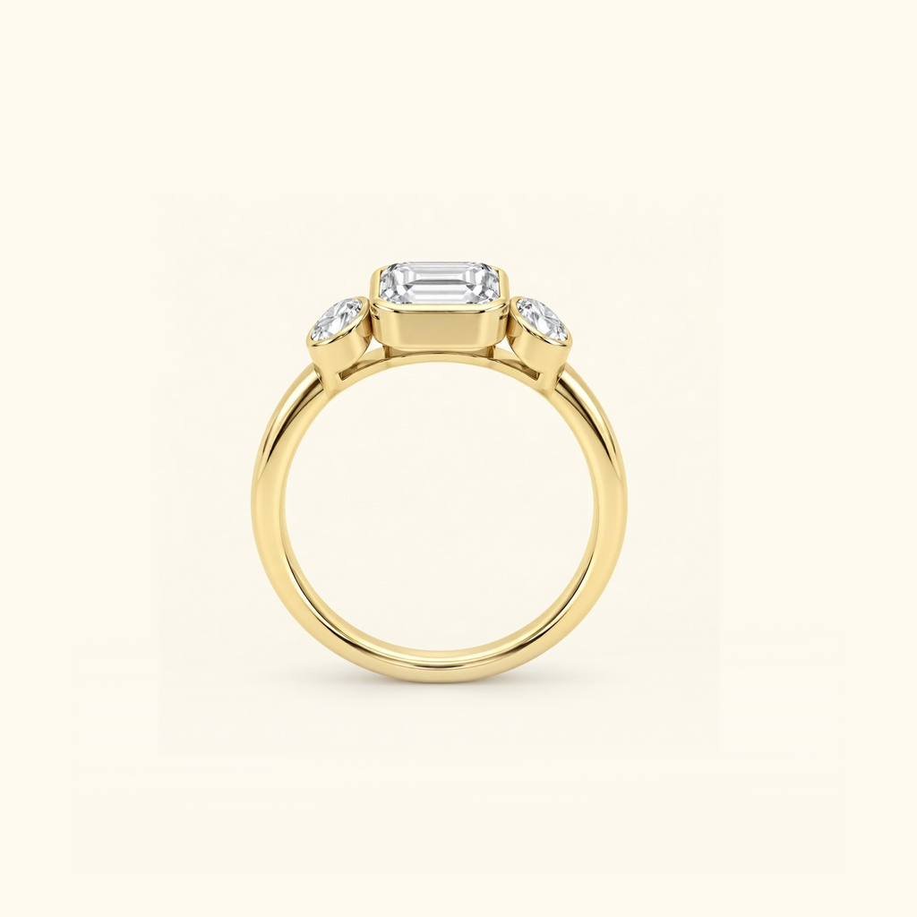 Clio Three-Stone ring in 14K yellow gold standing upright, showing the slim band and three bezel-set stones
variant: yellow-gold