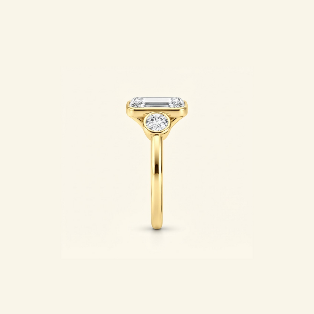 Side profile of the Clio Three-Stone ring in 14K yellow gold, showing the low bezel setting
variant: yellow-gold