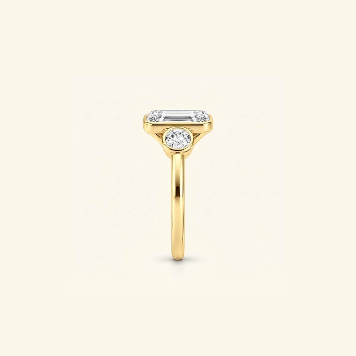 Side profile of the Clio Three-Stone ring in 14K yellow gold, showing the low bezel setting
variant: yellow-gold