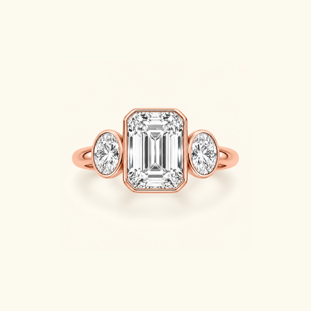 Clio Three-Stone ring in 14K rose gold with a bezel-set emerald-cut lab diamond between two oval side stones
variant: rose-gold