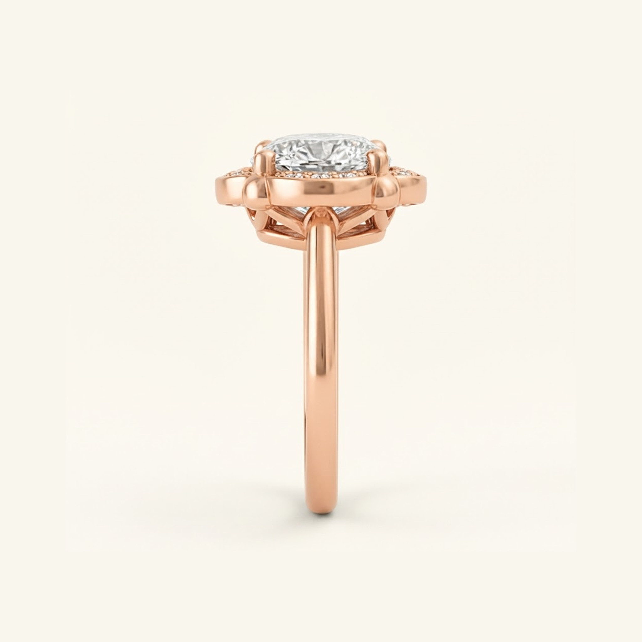 Side profile of the Elise Ring in rose gold, showing the scalloped halo, open gallery beneath the stone, and smooth band.

variant: rose-gold