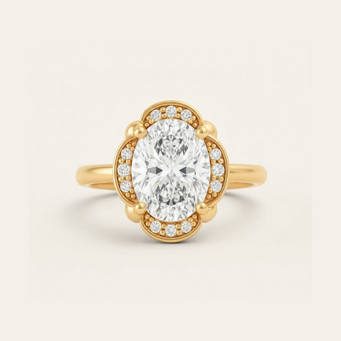 Elise Ring in yellow gold with an oval center diamond in a scalloped halo with beaded milgrain detail, on a cream background.

variant: yellow-gold