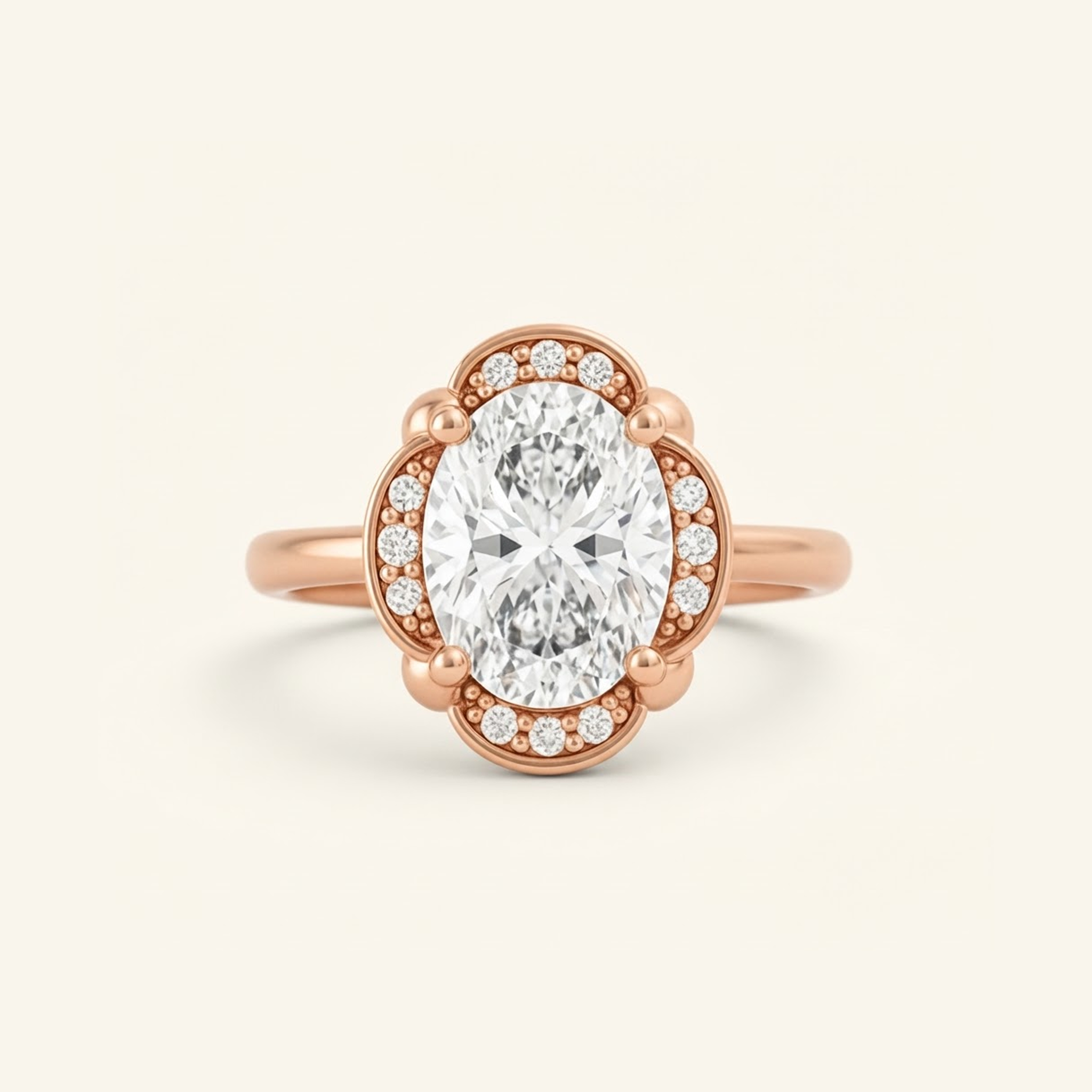 Elise Ring in rose gold with an oval center diamond in a scalloped halo with beaded milgrain detail, on a cream background.

variant: rose-gold