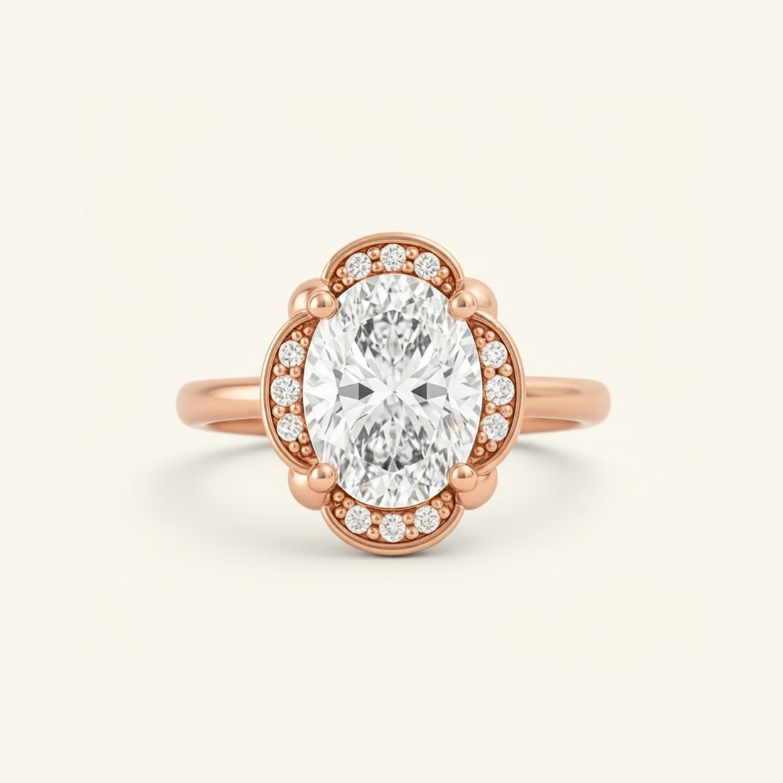Elise Ring in rose gold with an oval center diamond in a scalloped halo with beaded milgrain detail, on a cream background.

variant: rose-gold