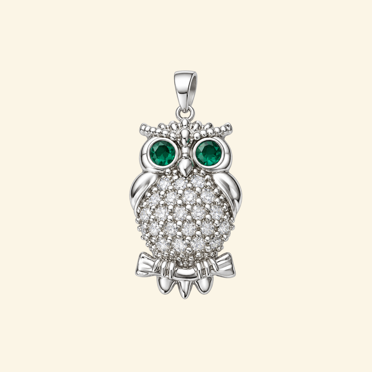 Close-up of the Elowen pendant in silver, an owl with green stone eyes, a pavé-set body, and beaded detailing.
variant: silver
