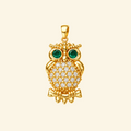 Close-up of the Elowen pendant in yellow gold, an owl with green stone eyes, a pavé-set body, and beaded detailing.
variant: yellow-gold