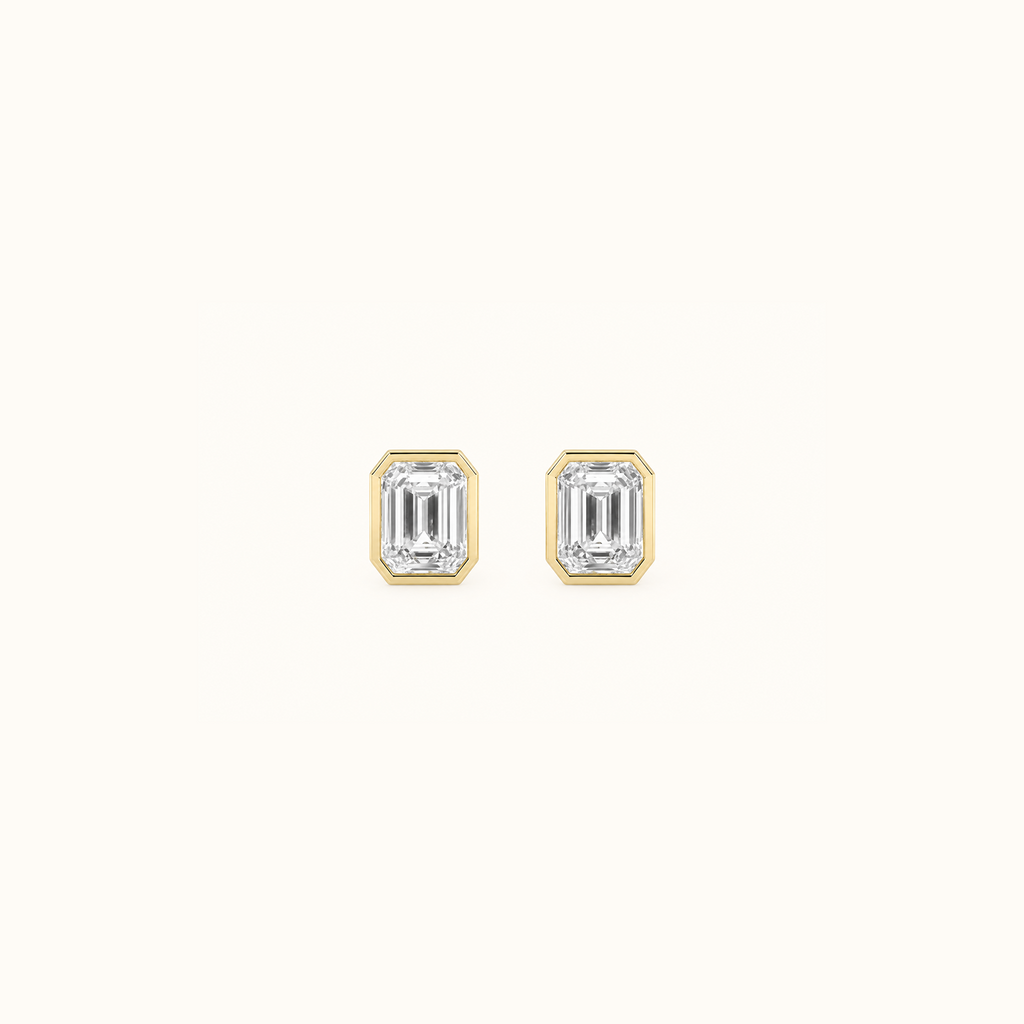 Everly bezel stud in yellow gold with an emerald-cut diamond, shown from the front and side to reveal the post and butterfly back