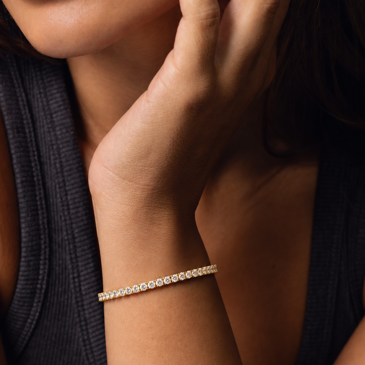 Everly tennis bracelet in yellow gold worn on a woman’s wrist, her hand resting at her shoulder
variant: yellow-gold