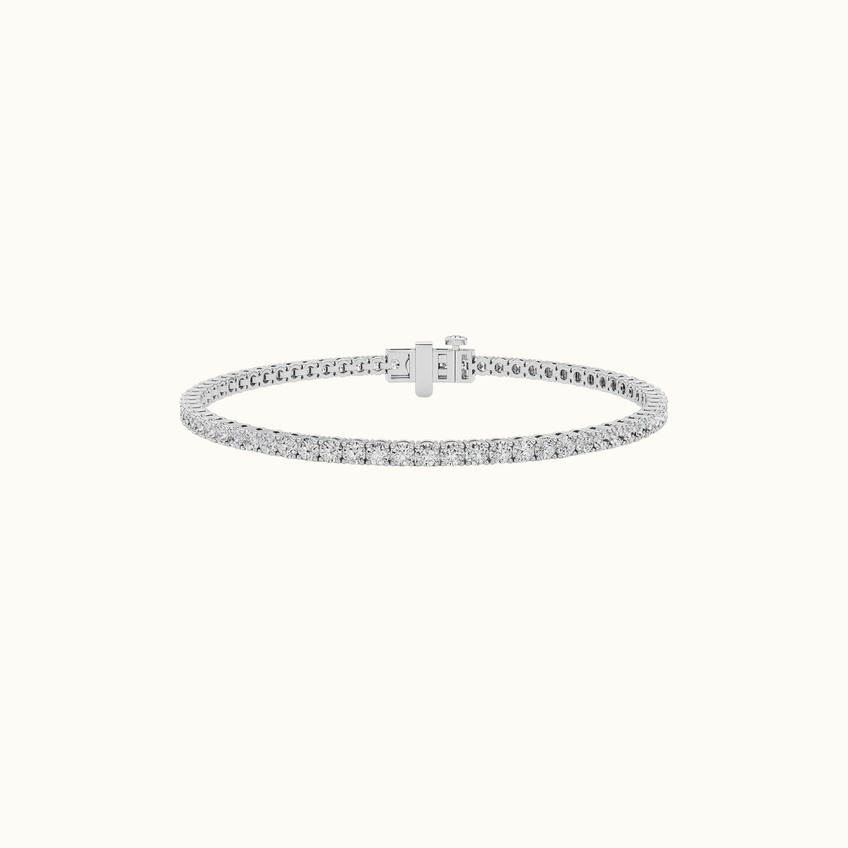 Everly tennis bracelet in white gold with a continuous row of round diamonds and a hidden box clasp, on a cream background
variant: white-gold