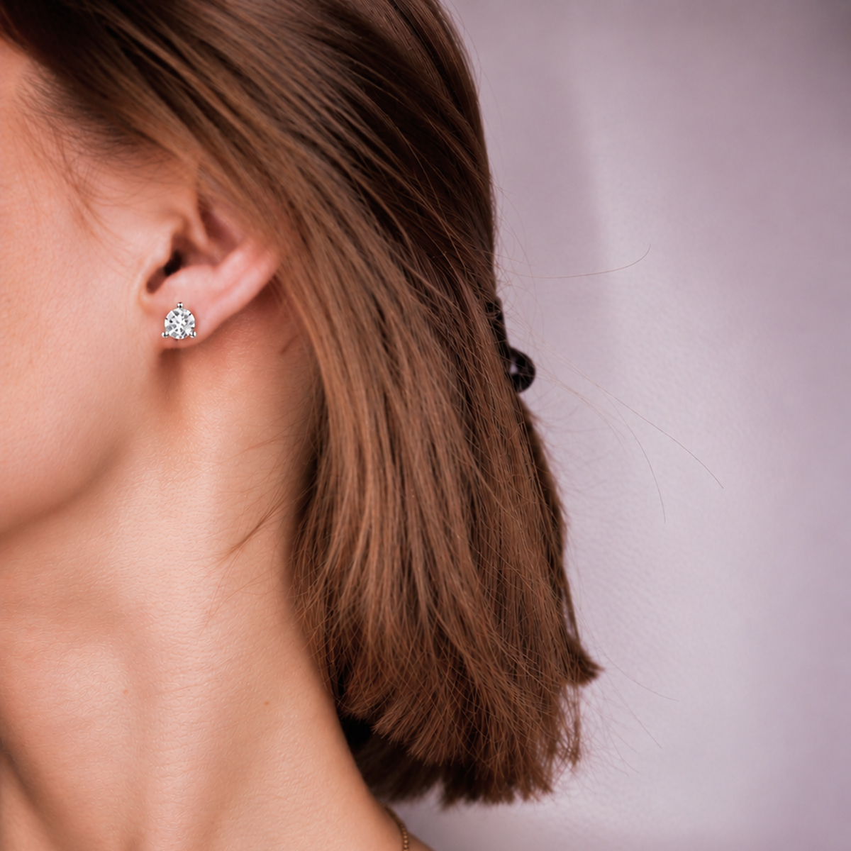 Everly Martini Stud worn on the ear, a single round diamond sitting close to the earlobe