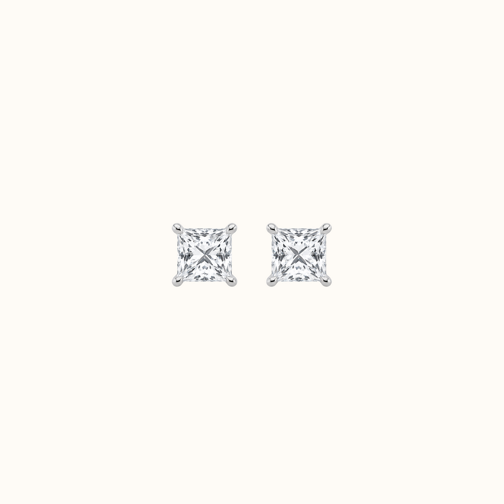 Everly princess-cut diamond stud earrings in 14K white gold, pair shown front-facing on cream