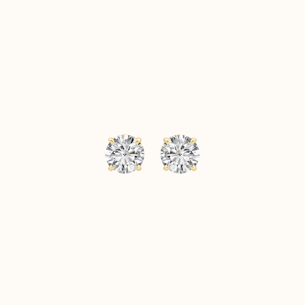 Everly round brilliant diamond stud earrings in 14K yellow gold, pair shown front-facing on cream
variant: yellow-gold