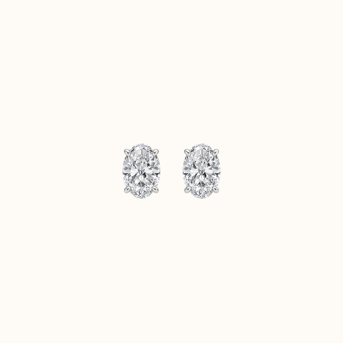 Everly oval brilliant diamond stud earrings in rhodium-finished sterling silver, pair shown front-facing on cream
variant: silver