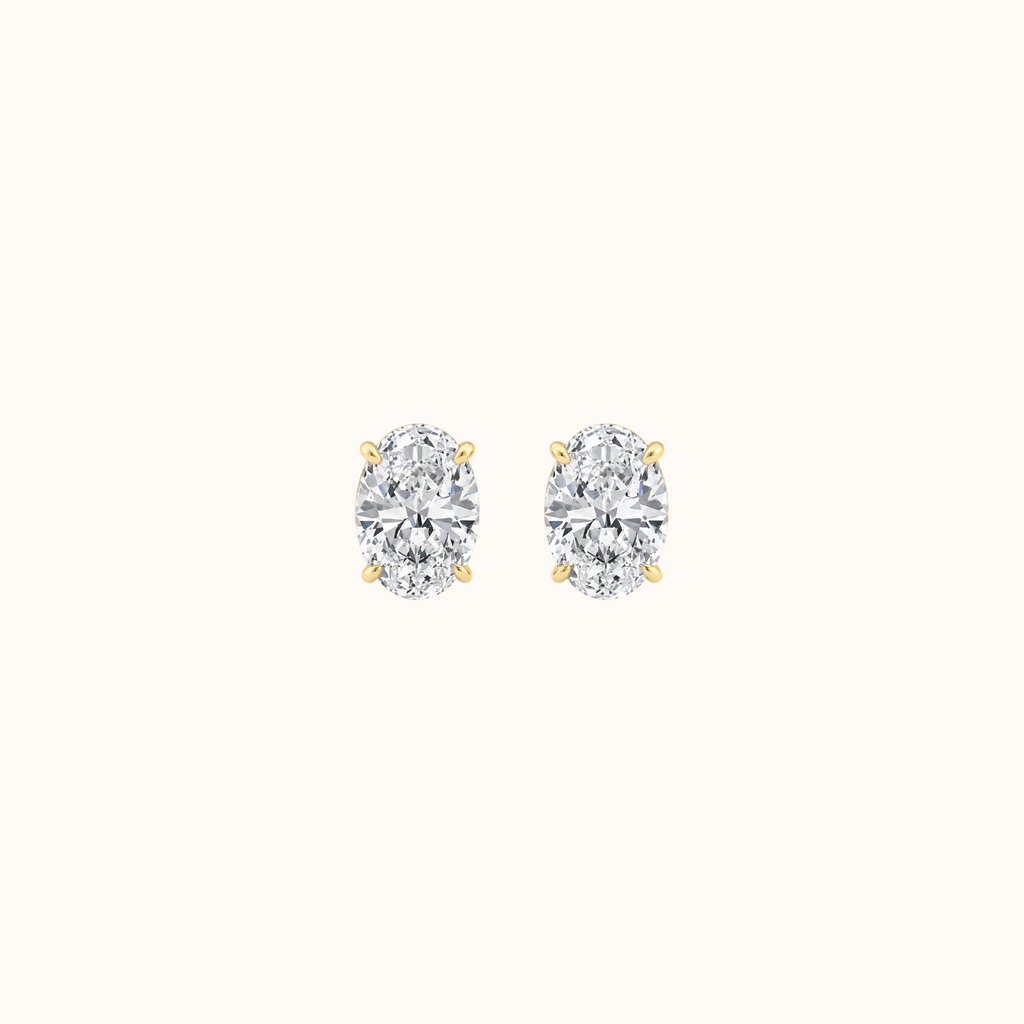 Everly oval-cut diamond stud earrings in 14K yellow gold, pair shown front-facing on cream
variant: yellow-gold
