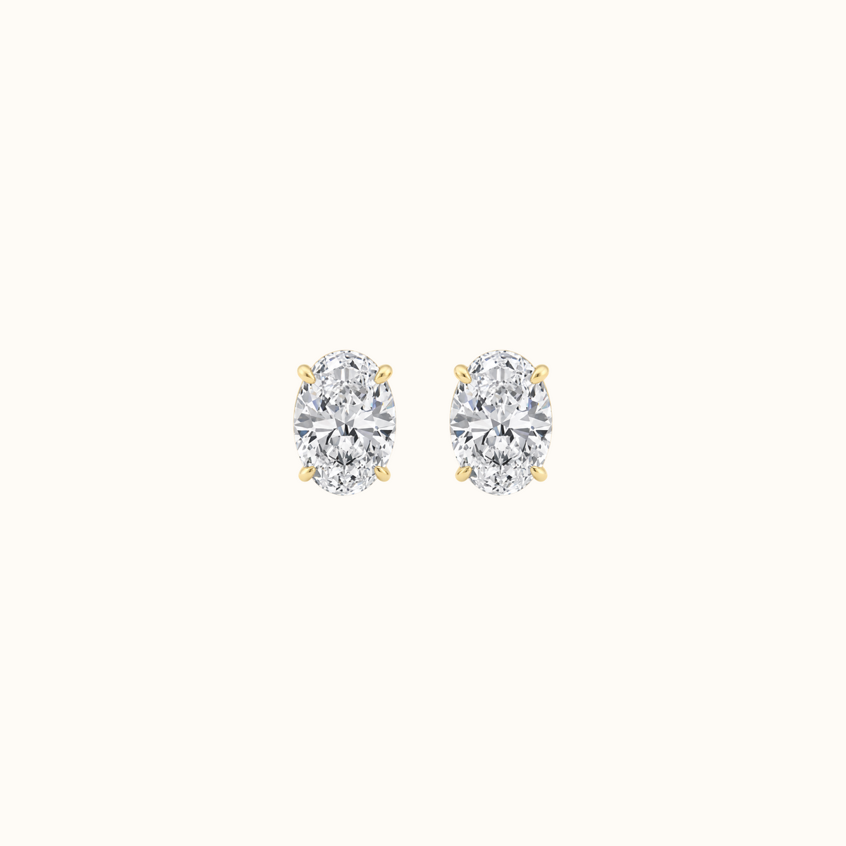 Everly oval-cut diamond stud earrings in 14K yellow gold, pair shown front-facing on cream
variant: yellow-gold