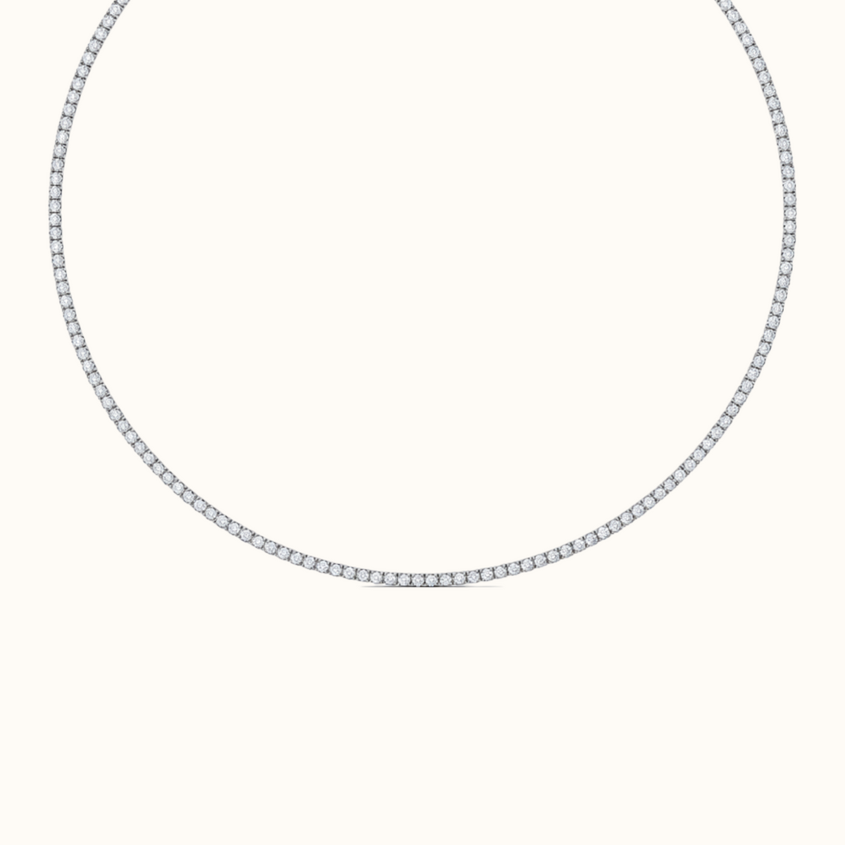 Everly tennis necklace in rhodium-finished sterling silver, a single row of round diamonds laid in a circle on a cream background
variant: silver