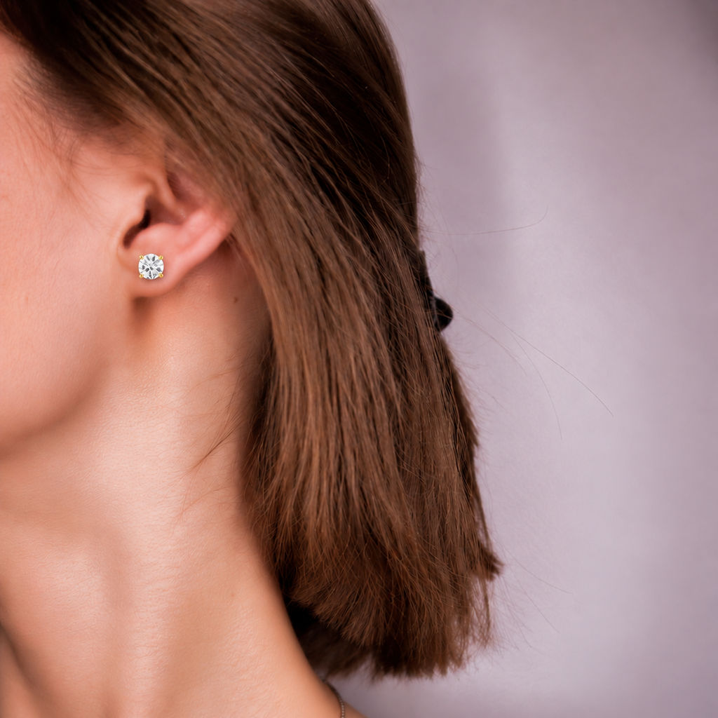Model wearing an Everly round diamond stud, side profile with hair tucked behind the ear
variant: yellow-gold
