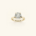 Everly solitaire engagement ring in yellow gold with a 1ct round diamond in a four-prong setting, on a cream background
variant: yellow-gold