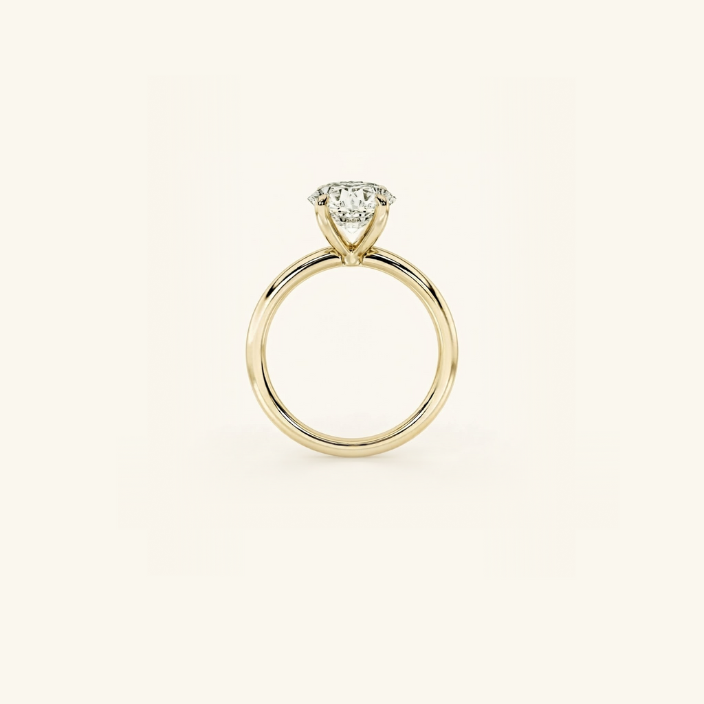 Everly solitaire ring in yellow gold seen edge-on, showing the band’s profile and the height of the four-prong setting
variant: yellow-gold
