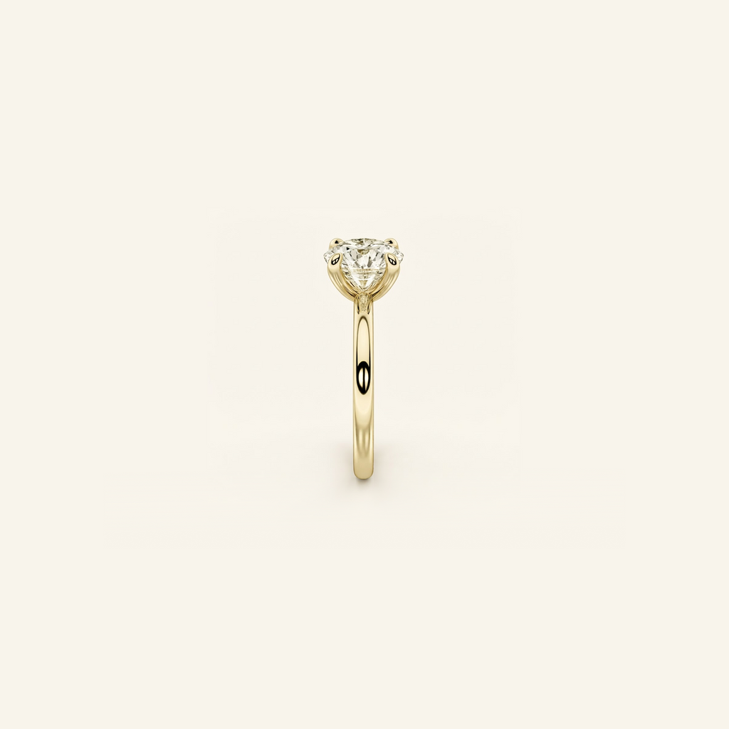 Everly solitaire ring in yellow gold from the side, showing the raised four-prong setting and slim band
variant: yellow-gold