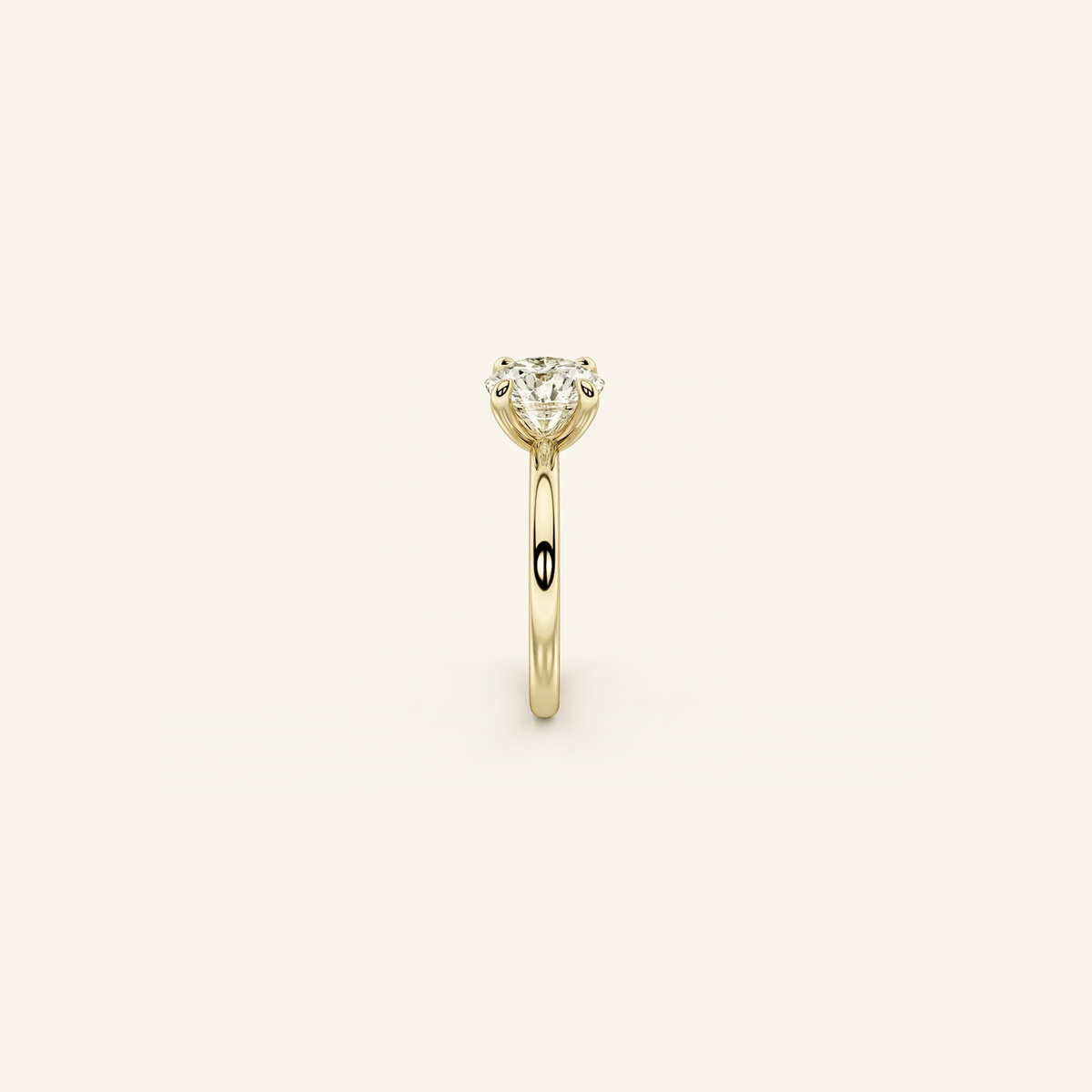 Everly solitaire ring in yellow gold from the side, showing the raised four-prong setting and slim band
variant: yellow-gold