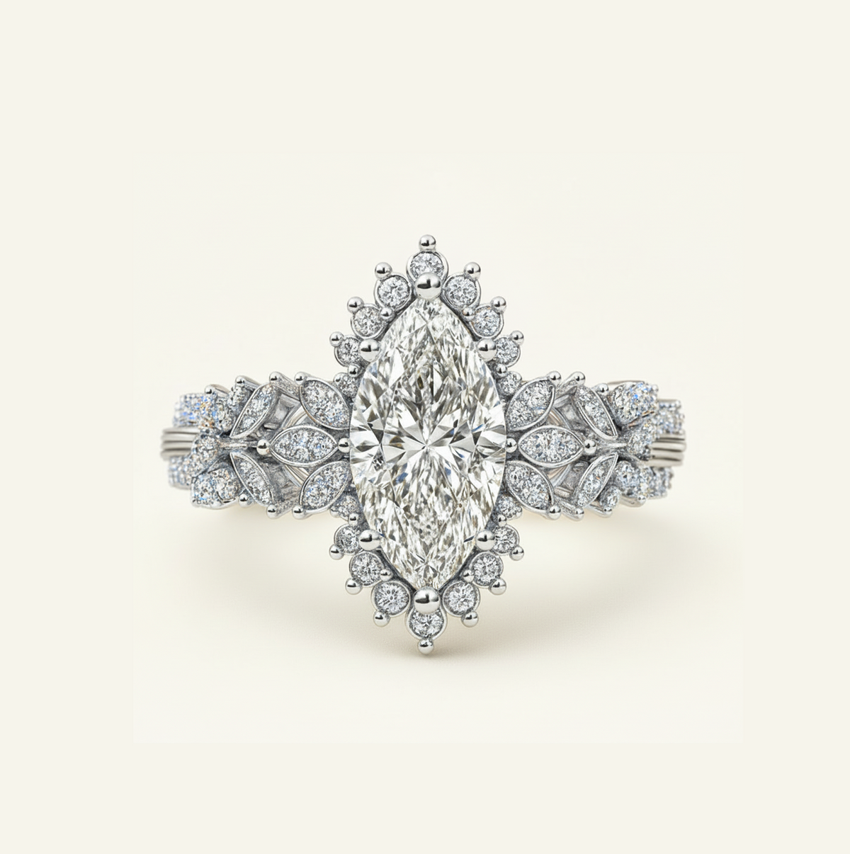 Flora Ring in white gold with a marquise center diamond, starburst diamond halo, and leaf-inspired pavé band, on a cream background.
variant: white-gold