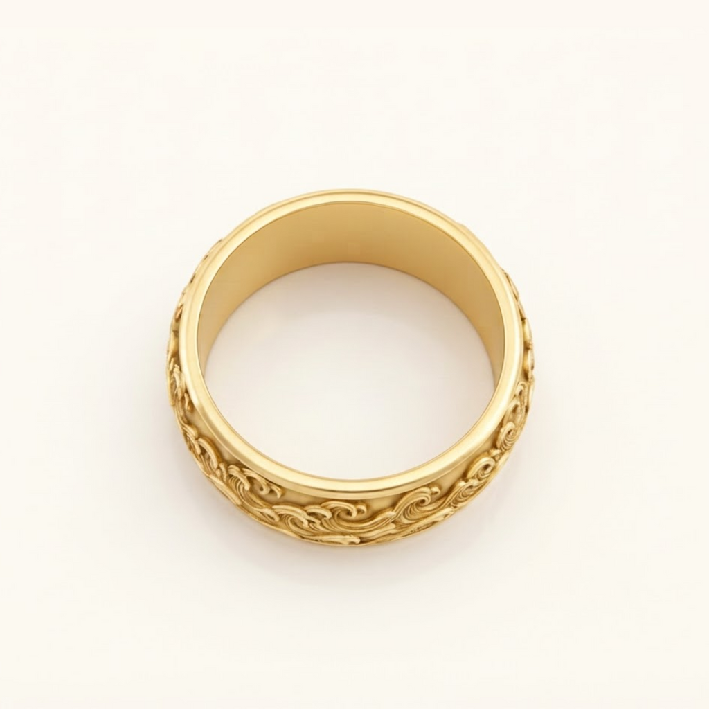 Top-down view of the Kai Ring in yellow gold, showing the band’s width and the wave relief along its edge.
variant: yellow-gold