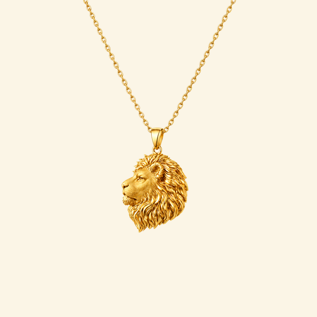 Leo Necklace in yellow gold, a sculpted lion head pendant on a fine cable chain, on a cream background.
variant: yellow-gold