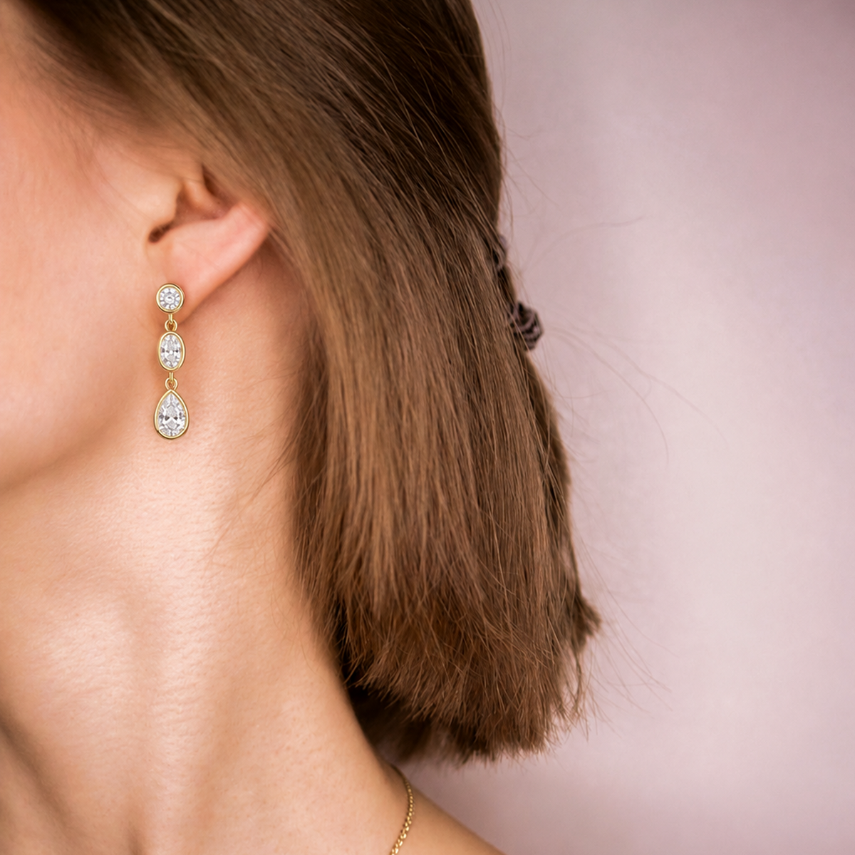Mosaic Drop worn on the ear, three bezel-set diamonds in yellow gold falling below the earlobe
variant: yellow-gold