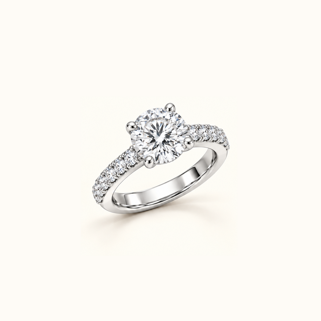 Noelle ring in white gold at an angle, showing the raised round center diamond and pavé band
variant: white-gold