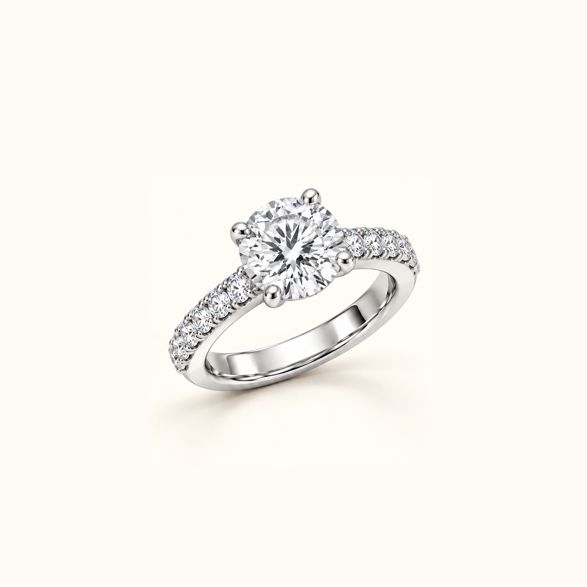 Noelle ring in white gold at an angle, showing the raised round center diamond and pavé band
variant: white-gold