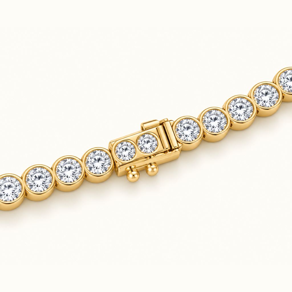 Close-up of the Orbit Riviera in 14K yellow gold, showing the bezel-set diamonds and the box clasp
variant: yellow-gold