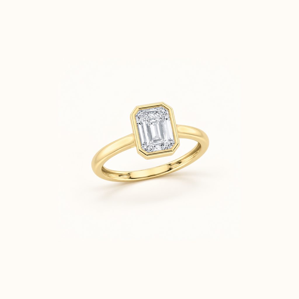 Orbit ring at an angle in 14K yellow gold with a 1ct emerald diamond in a smooth bezel setting
variant: yellow-gold