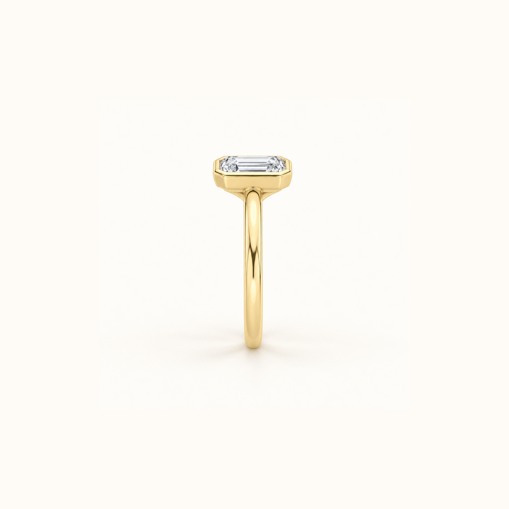 Side view of Orbit ring in 14K yellow gold with a 1ct emerald diamond in a smooth bezel setting
variant: yellow-gold