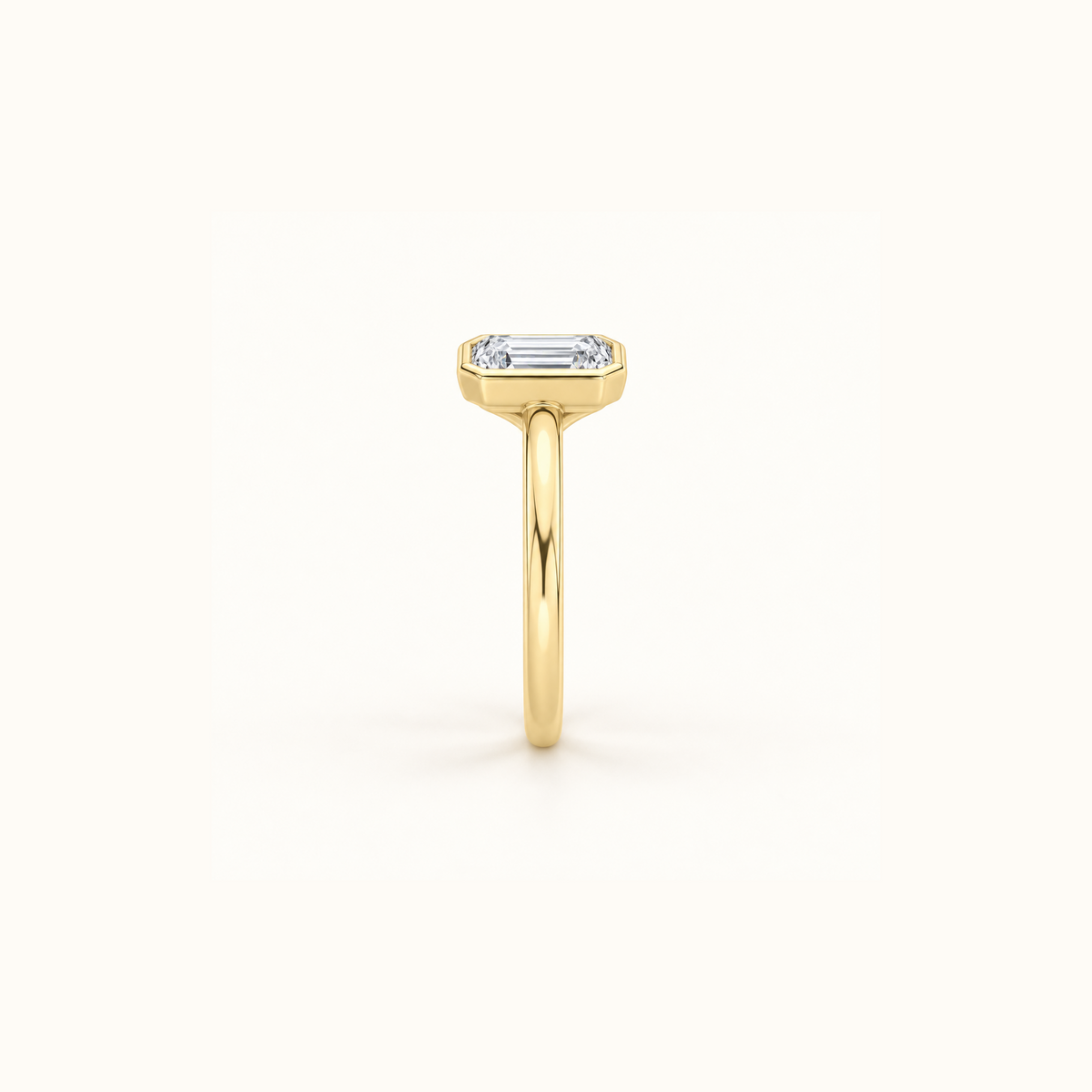 Side view of Orbit ring in 14K yellow gold with a 1ct emerald diamond in a smooth bezel setting
variant: yellow-gold